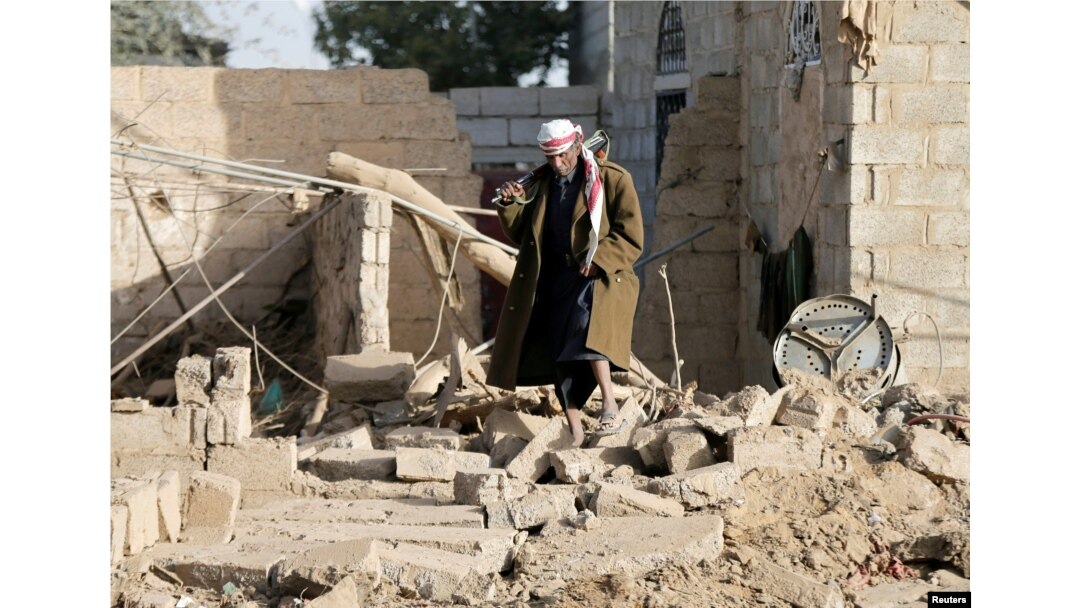 A man walks at the site of a Saudi-led air strike in the Houthi-held capital Sanaa, Yemen, Jan. 20, 2019.