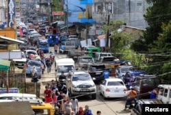 FILE - Residents who stayed at evacuation centers, because of the assault of government troops against pro-Islamic State militant groups, were allowed to return to their homes in Basak, Malutlut district in Marawi city, southern Philippines, Oct. 29, 2017.