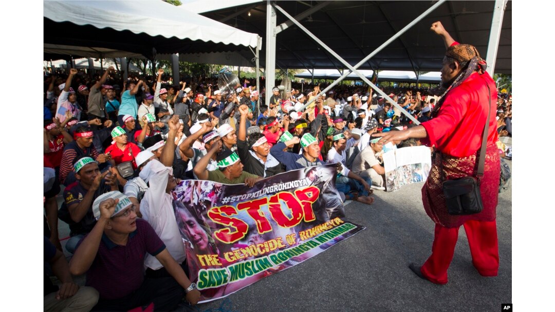 Myanmar ethnic Rohingya Muslims raise clenched fists during a protest against the persecution of Rohingya Muslims in Myanmar, in Kuala Lumpur, Malaysia, Dec. 4, 2016.