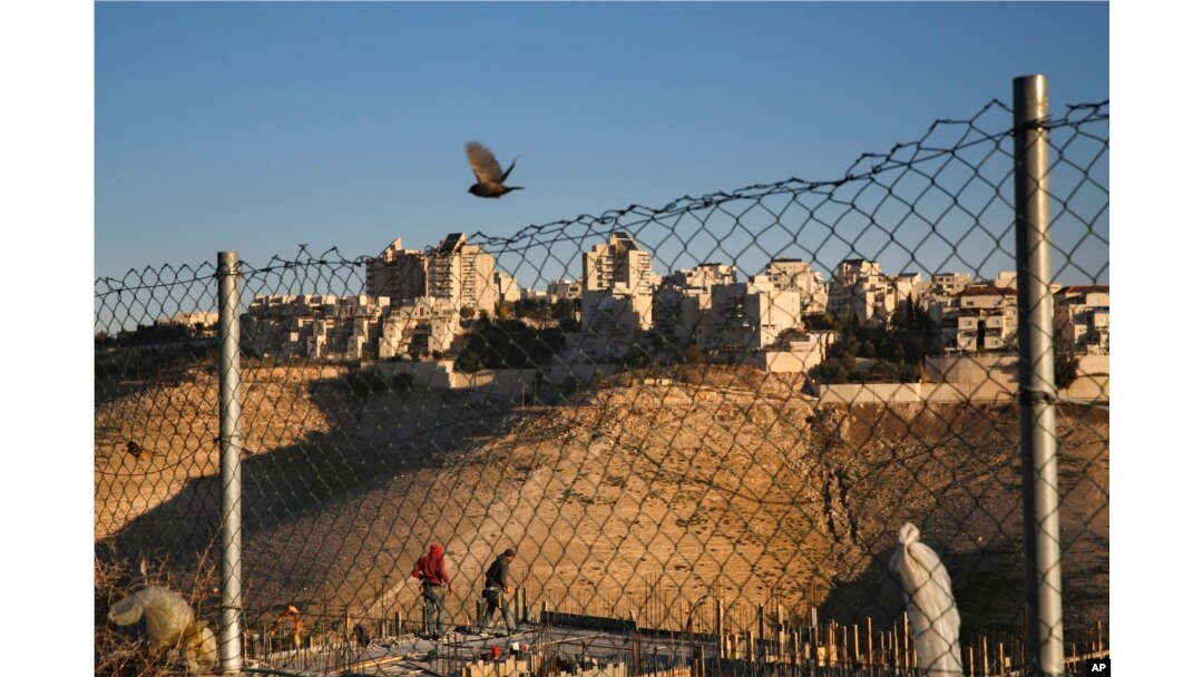 Palestinian laborers work at a construction site in a new housing project in the Israeli settlement of Maale Adumim, near Jerusalem, Feb. 7, 2017.