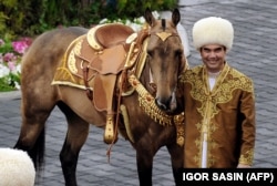 TURKMENISTAN -- Turkmen President Gurbanguly Berdimuhamedov poses with an ancient Akhal-Teke breed three years old studhorse, Begkhan, that won an International Annual Horse Beauty contest in Ashgabat on April 23, 2016.