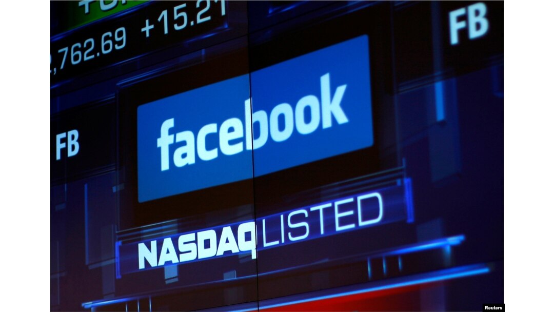 FILE - Monitors displays the Facebook stock during morning trading at the NASDAQ Marketsite in New York, NY, June 4, 2012.
