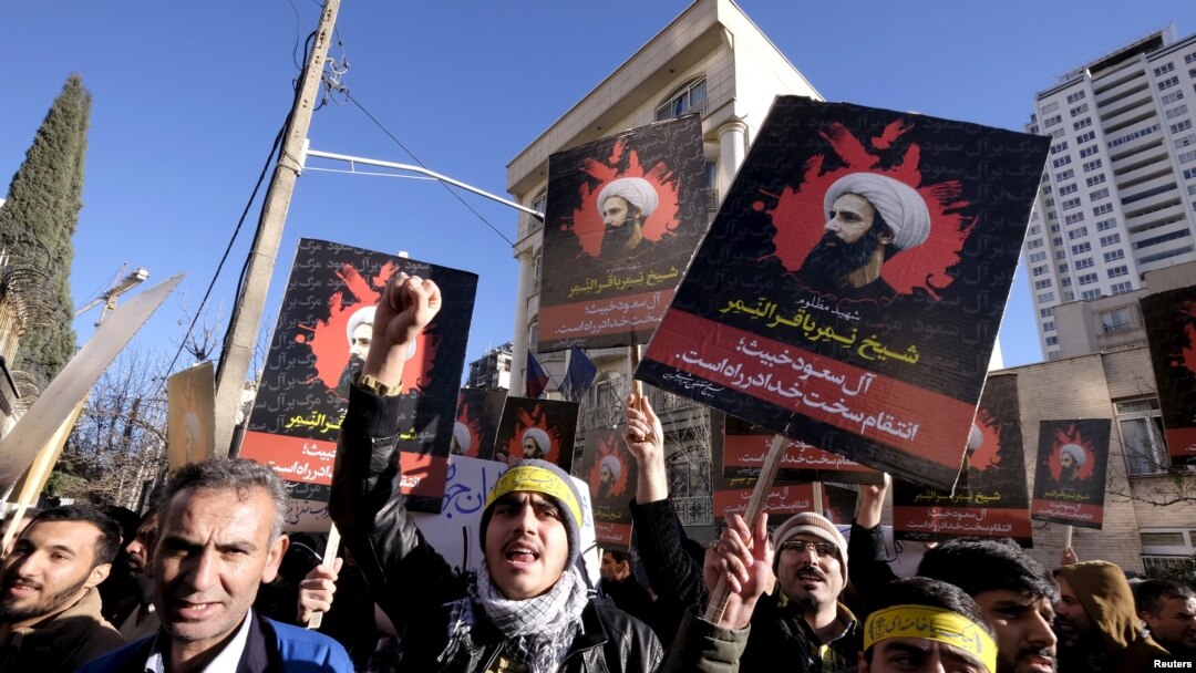 Iranian protesters chant slogans as they hold pictures of Shi'ite cleric Sheikh Nimr al-Nimr during a demonstration against his execution in Saudi Arabia, outside the Saudi Arabian Embassy, in Tehran Jan. 3, 2016.