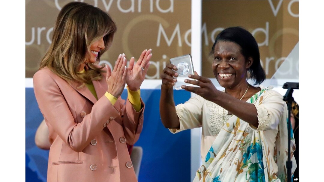 Godelieve Mukasarasi of Rwanda, holds up her award presented by first lady Melania Trump at the 2018 International Women of Courage awards, March 23, 2018, at the State Department in Washington.