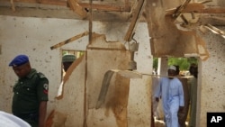 FILE - People inspect a damaged mosque following a suicide bomb explosion led by two women in Maiduguri, Nigeria, March 16, 2016. UNICEF said Tuesday that Boko Haram has increased "tenfold" the use of children as suicide bombers.
