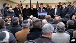 French interior minister Bernard Cazeneuve, center, during a gathering against anti-semitism also attended by Israeli ambassador to France Yossi Gal, left, in Creteil, east of Paris, Dec. 7, 2014.