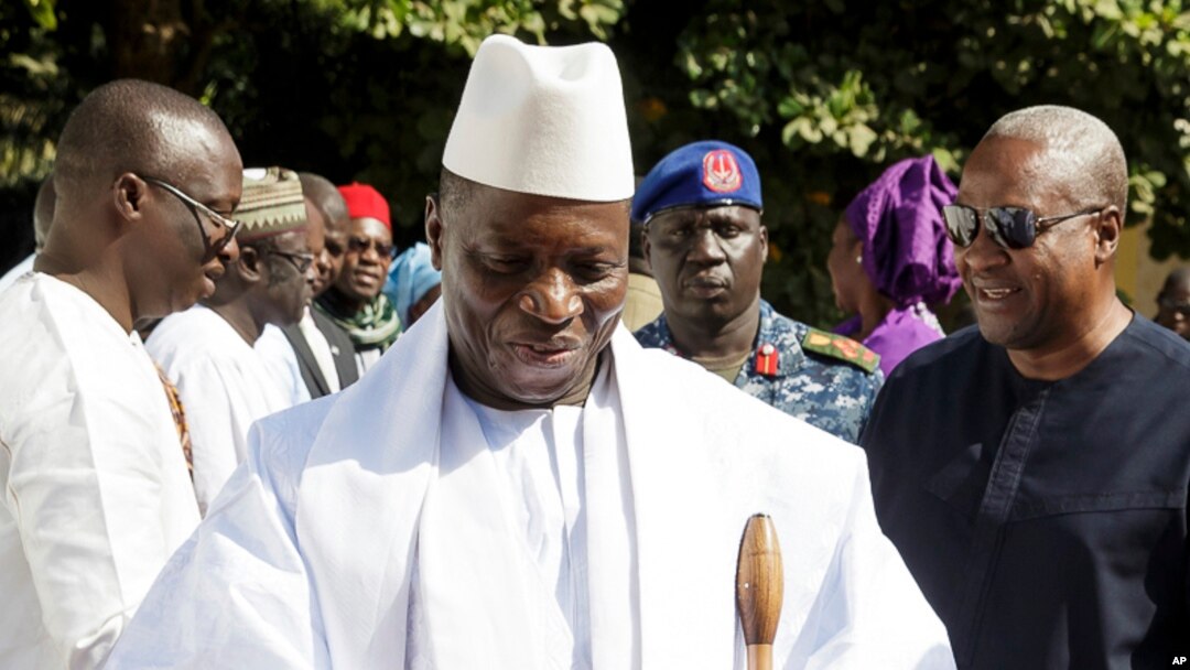 FILE - In this photo released by the Nigeria State House, Gambia's Yahya Jammeh, walk along side with Nigeria President Muhammadu Buhari (not seen), upon arrival in Banjul, Jan.13, 2017. 
