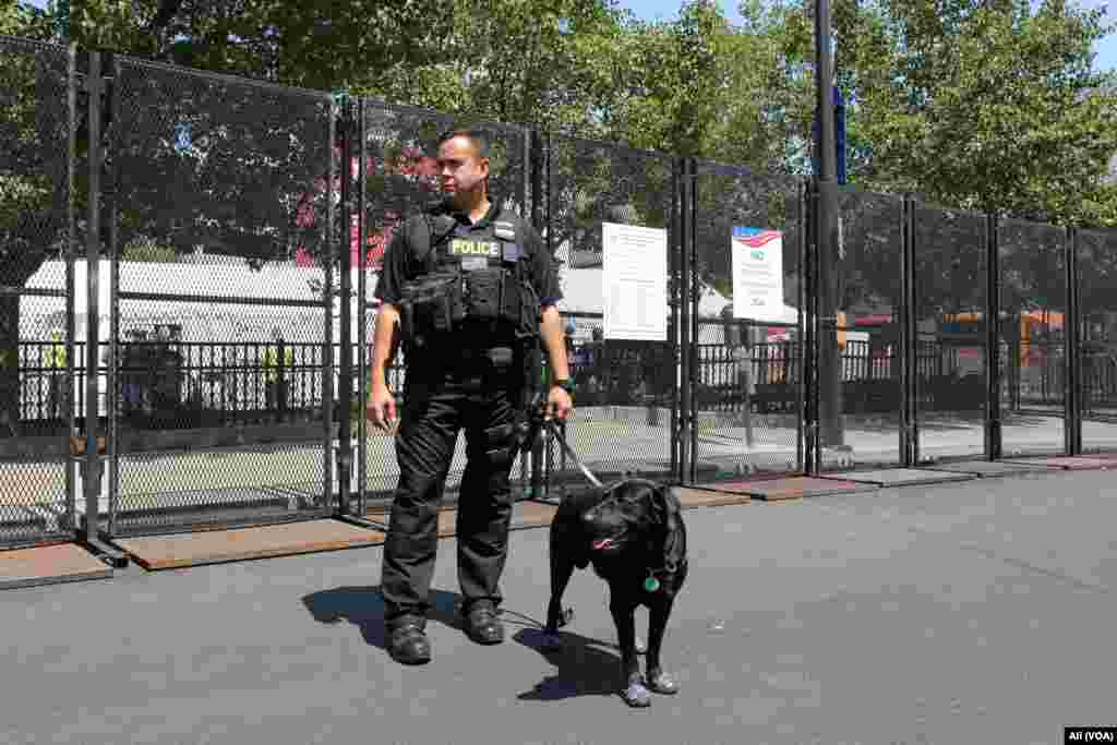 A K-9 officer and his dog stand guard outside the Quicken Loans Arena, where the Republican National Convention is being held, in Cleveland, July 19, 2016.