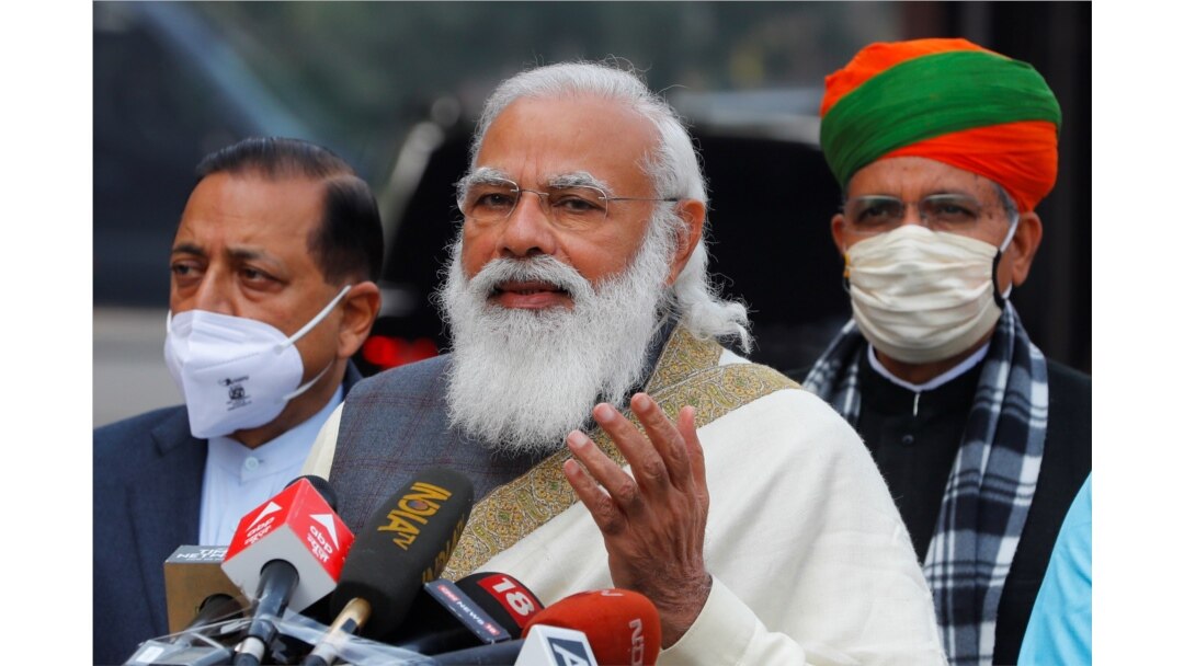 India's Prime Minister Narendra Modi speaks with the media as he arrives at the parliament house to attend the first day of the budget session, in New Delhi, India, Jan. 29, 2021.