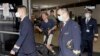 FILE - Crew from China Eastern Airlines leave the airport wearing face masks after arriving in Sydney, Jan. 23, 2020, on a flight from Wuhan, China. 