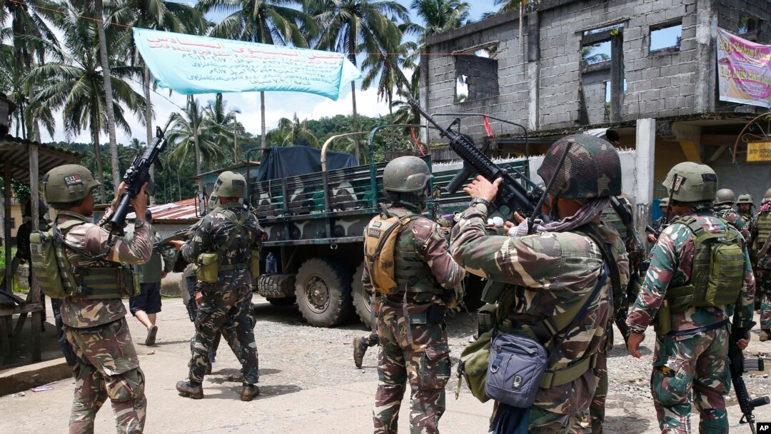 FILE - In this May 30, 2017 photo, Philippines government troops prepare to head to the frontline as fighting with Muslim militants in Marawi city continued in southern Philippines. 