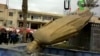 A statue of President Bashar Al-Assad's father, Hafez Al-Assad, is pulled down as people celebrate in Raqqa Mar. 4, 2013.