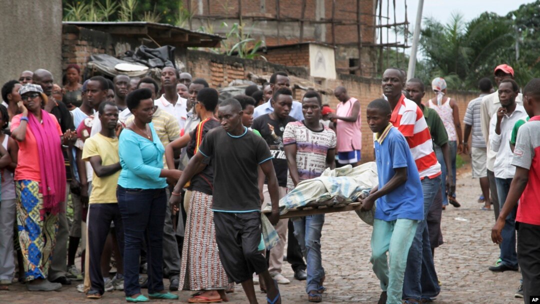Men carry a body in the Nyakabiga neighborhood of Bujumbura, Burundi, where a number of people were found shot dead a day after the government said an unidentified group had carried out attacks on three military installations, Dec. 12, 2015.