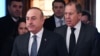 Russian Foreign Minister Sergei Lavrov, right, and his Turkish counterpart, Mevlut Cavusoglu, enter a hall as they meet in Moscow, Russia, Dec. 20, 2016. 