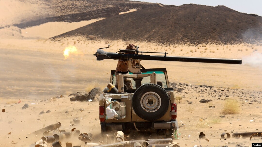 FILE - A Yemeni government fighter shoots a vehicle-mounted weapon at a frontline position during a battle against Houthi fighters in Marib, Yemen, March 9, 2021. An explosion near a petrol station in Marib killed at least 12 on June 5, 2021. 