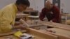 Mark Gatterdam, one of six partners, all craftsmen, who own and operate Hardwood Artisans, works with a customer. (Photo by Erin Gallagher) 