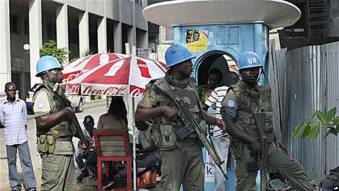 UN forces stand guard on a street in Abidjan, Ivory Coast, Dec 22, 2010