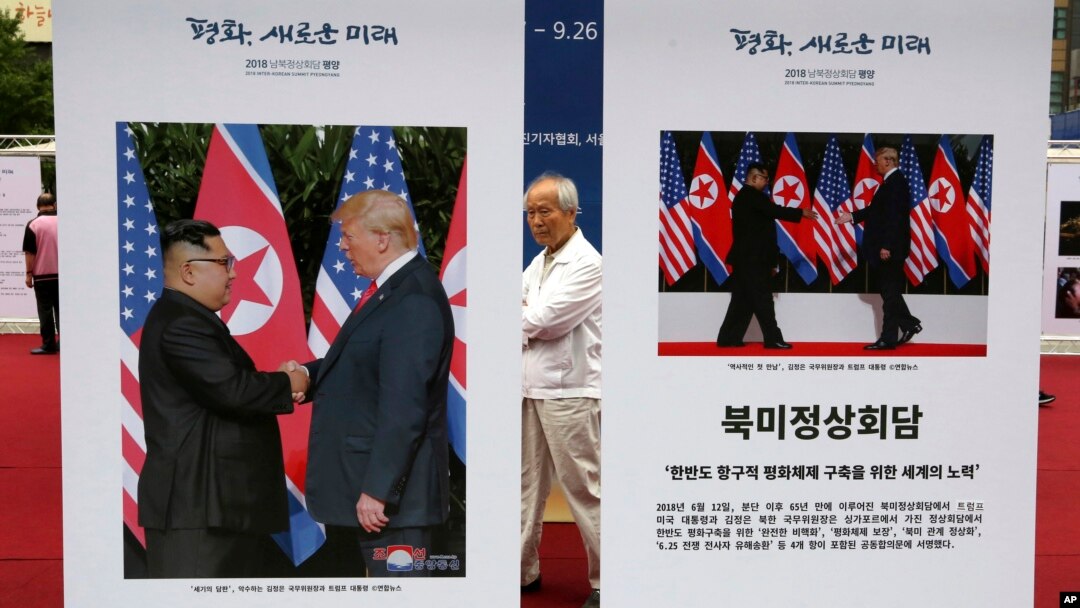 Photos of the summit between U.S. President Donald Trump and North Korean leader Kim Jong Un are displayed during a photo exhibition to wish for peace on the Korean Peninsula in Seoul, South Korea, Wednesday, Sept. 19, 2018. 