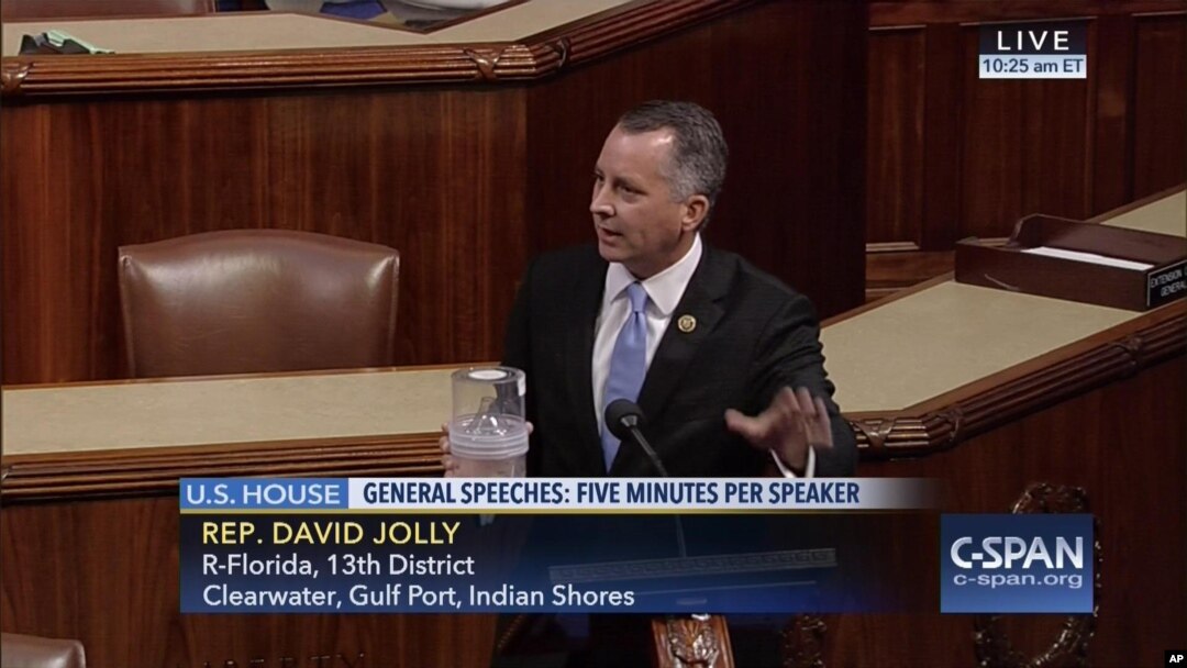 In this frame grab from video provided by C-SPAN, Rep. David Jolly, R-Fla. holds a container of mosquitoes while speaking of the House floor on Capitol Hill in Washington, Sept. 7, 2016. "The politics of Zika are garbage right now," the Florida lawmaker said in a short, angry speech condemning Congress for failing to pass legislation providing $1.1 billion to combat the mosquito-borne virus.