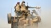 Shi'ite fighters ride on a military vehicle heading toward the airport of Tal Afar during a battle with Islamic State militants in Tal Afar, Iraq, Nov. 16, 2016. 