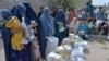 Afghan women receive food donations as part of the World Food Program (WFP) for displaced people, during the Islamic holy month of Ramadan in Jalalabad, Apr. 20, 2021.