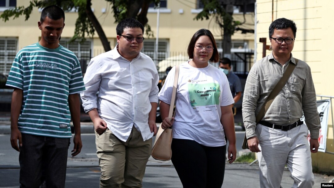 Panupong "Mike Rayong" Jadnok, Parit "Penguin" Chiwarak, Panusaya "Rung" Sithijirawattanakul and Arnon Nampa, a rights lawyer and protest leader arrive to report themselves to police summons at a police station in Bangkok, Thailand, Nov. 30, 2020. 