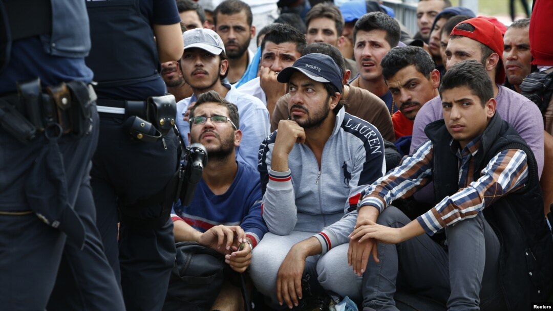 FILE - Migrants wait to cross the border from Austria near Freilassing, Germany, Sept. 17, 2015. The U.S. House of Representatives, which recently voted to suspend Syrian refugee resettlement, plans to take up a bill on visa waivers, an emerging risk.