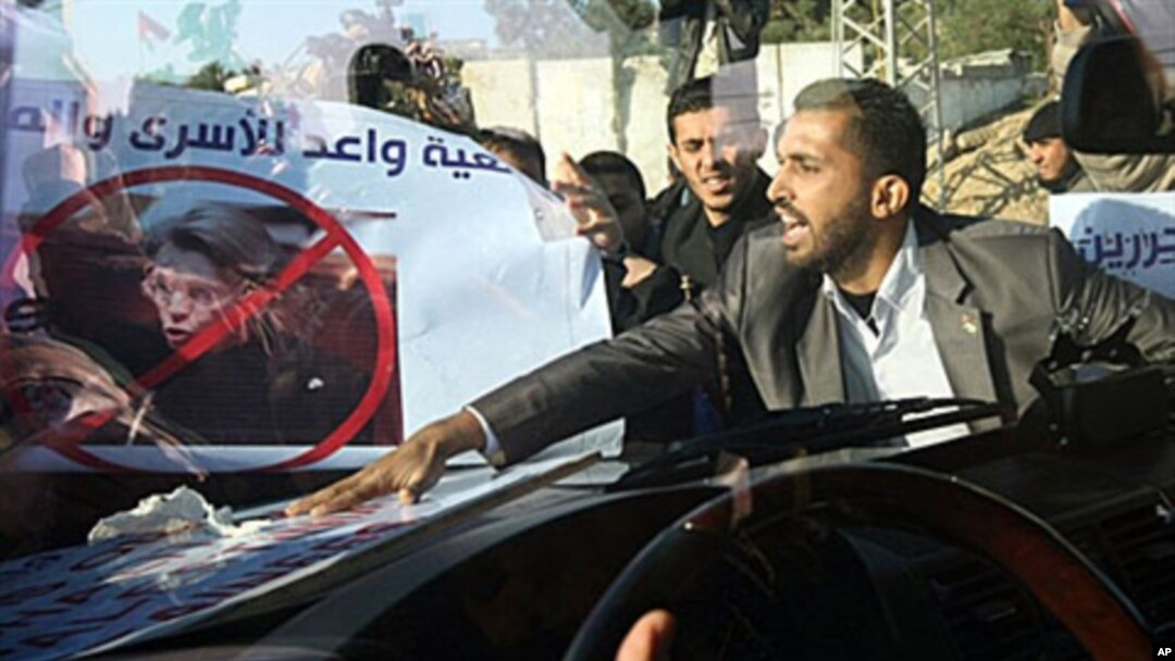 Angry Palestinian demonstrators mob French Foreign Minister Michele Alliot-Marie's armored car at Beit Hanun in the Gaza Strip, 21 Jan 2011