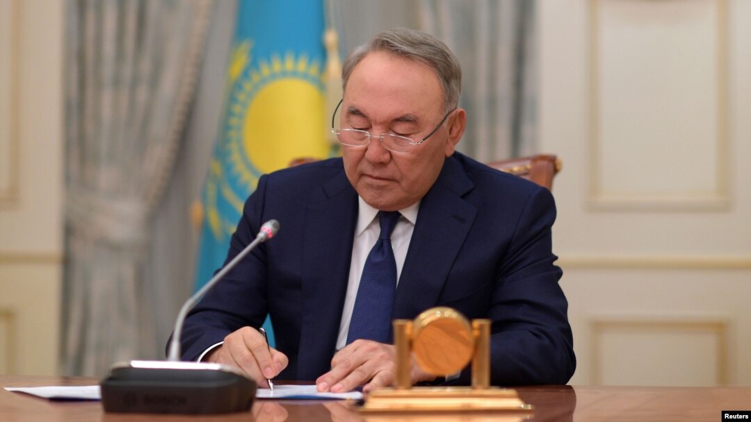 Kazakh President Nursultan Nazarbayev writes during a televised address to announce his resignation, in Astana, Kazakhstan, March 19, 2019.