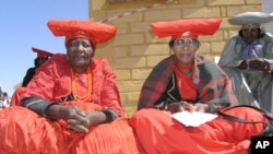 Herero women attend a gathering in Okokarara, Namibia, Aug. 14, 2004 where Germany's Development Aid Minister, Heidemarie Wieczorek-Zeul, unseen, offered Germany's first apology for a colonial-era crackdown that killed 65,000 ethnic Hereros between 1904 and 1908. 