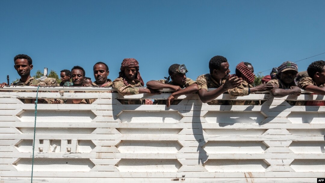 Members of the Amhara special forces look out from the back of a parked truck in Dansha, in the Tigray region of Ethiopia, Nov. 25, 2020.