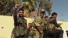 In this image made from video posted online by Qasioun News Agency, members of a Turkish-backed Syrian opposition force patrol in Dabiq, Syria, Oct. 16, 2016. 