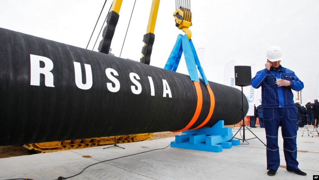FILE - A Russian construction worker speaks on a mobile phone during a ceremony marking the start of Nord Stream pipeline construction in Portovaya Bay some 170 kms (106 miles) northwest from St. Petersburg, Russia, April 9, 2010. 
