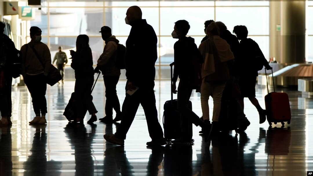 FILE - Air travelers line up to go through a a security checkpoint at Salt Lake City International Airport in Salt Lake City, on Nov. 25, 2020. 