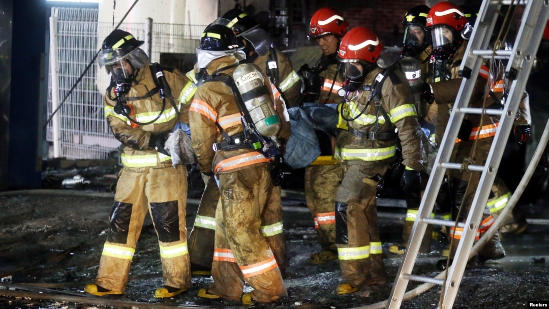 A victim is carried by firefighters in Jecheon, South Korea, Dece. 21, 2017. 