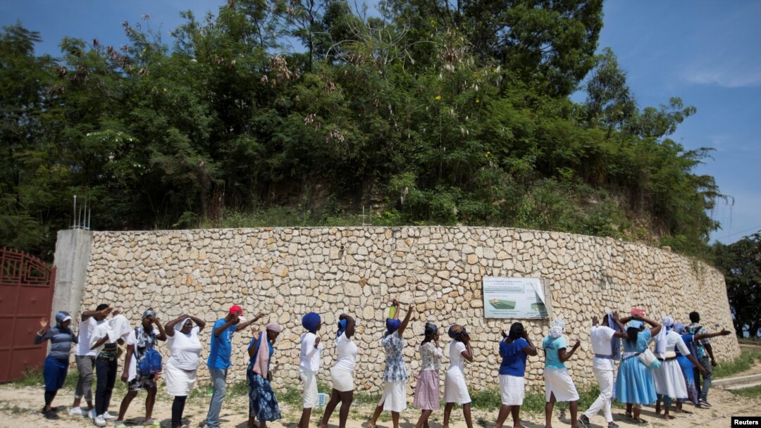 Believers gather to pray outside the church of St. Rock for the release of clergy members, including two French citizens, who were kidnapped, in Port-au-Prince, Haiti, April 12, 2021.