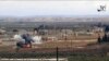 FILE - Image made from militant video posted online by the Aamaq News Agency, a media arm of the Islamic State group, Jan. 9, 2017, purports to show the moment of a Turkish missile strike, in the northern Syrian town of al-Bab, in Aleppo province, Syria. 