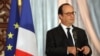 French President Francois Hollande gestures during joint news conference with Iraqi counterpart Fouad Massoum, Baghdad, Sept. 12, 2014.