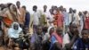 Newly arrived Somali refugees line up to wait for the reception center to open at Ifo settlement at Kenya's Dadaab Refugee Camp, situated northeast of the capital Nairobi near the Somali border, September 1, 2011. 