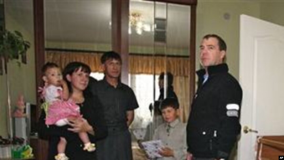 Russian President Dmitry Medvedev, right, visits an unidentified Russian family in the town of Yuzhnokurilsk, at the Pacific Island of Kunashir, Russia, 01 Nov 2010