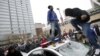 Protesters jump on a police car at a rally to protest the death of Freddie Gray who died following an arrest in Baltimore, April 25, 2015. 