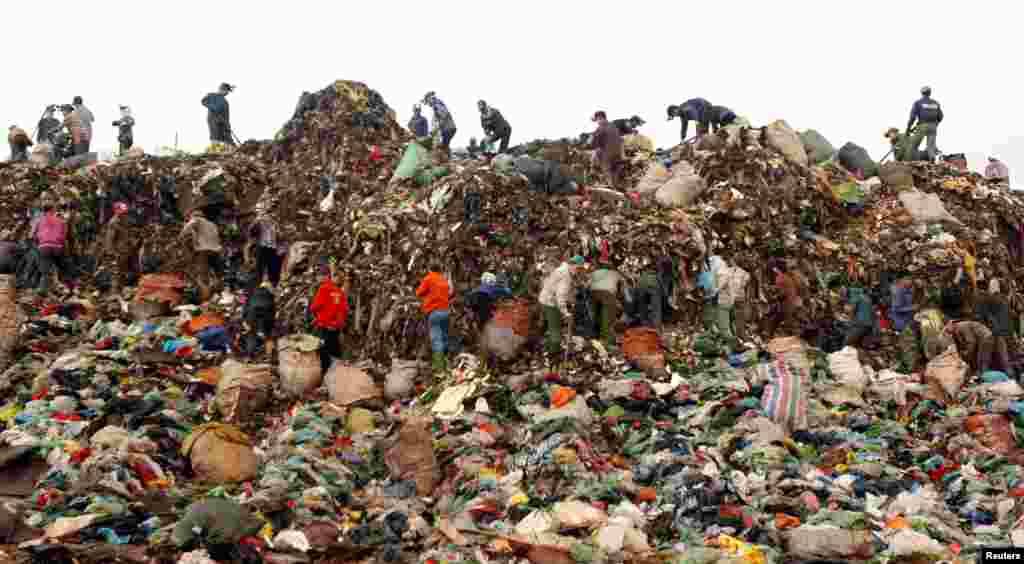 Scavengers search for recyclable materials to be sold to recycling centers, at the Nam Son garbage dump, north of Hanoi, Vietnam.