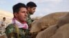Iranian Kurdish fighters stand watch on the Bashiqa front lines, Nov. 2, 2016. Last week, there were high Kurdish casualties during an offensive on the Islamic State-held town 30 kilometers from Mosul. (J. Dettmer/VOA)