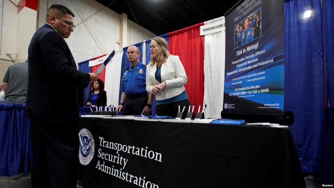 A veteran talks about job opportunities with a representative from Transportation Security Administration, TSA, at a military job fair in Sandy, Utah, U.S., March 26, 2019. 
