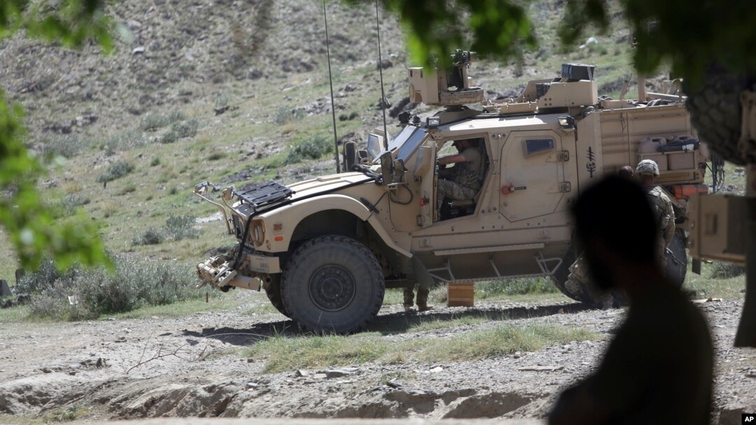 FILE - U.S. forces and Afghan commandos are seen in Asad Khil village in the Achin district of Jalalabad, Nangarhar province, Afghanistan, April 17, 2017.