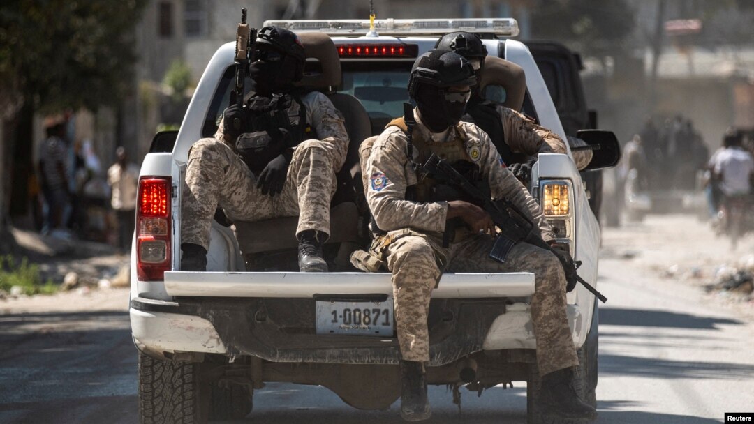FILE - Armed Haitian National Police officers escort the convoy of the three officers killed by armed gangs after the funeral ceremony at the National Police Academy, in Port-au-Prince, Haiti Jan. 31,2023. 