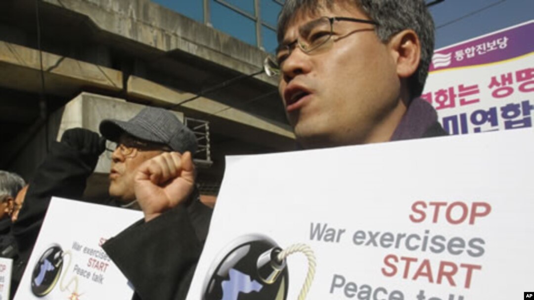 South Korean protesters shout slogans during a rally against the annual joint military exercises between South Korea and the United States, in front of the Yongsan U.S. Army headquarters in Seoul, South Korea, February 27, 2012.