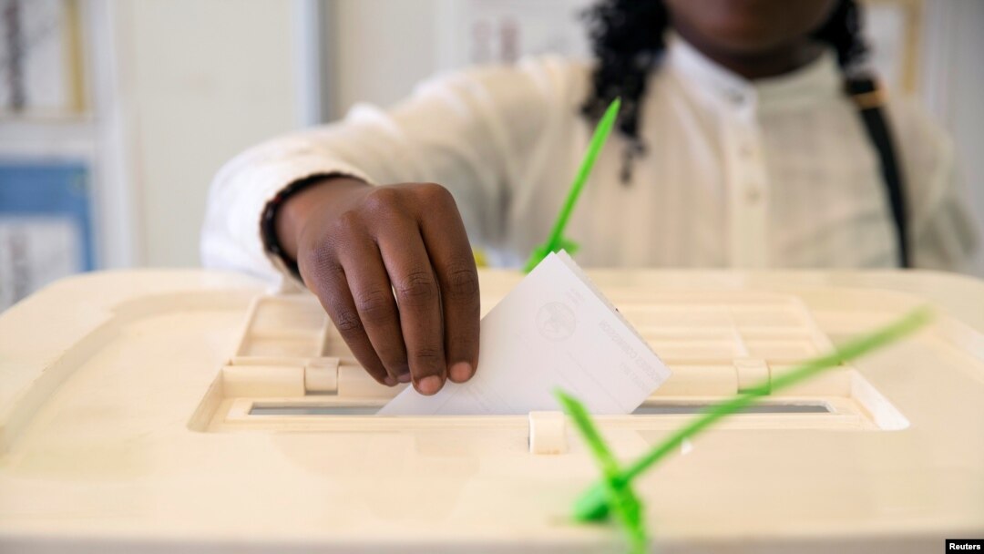 FILE - A Kenyan woman casts her vote at a mock polling station during a pre-election exhibition in Nairobi, June 12, 2017. 