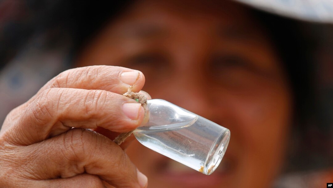 A local prospector displays flecks of gold found in the Klong Thong, or "Golden Canal" in Prachuap Khiri Khan province, southern Thailand, Jan. 19, 2017.
