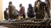 FILE - Journalists look at arms and ammunition which military commanders say they seized from Islamic fighters, in Maiduguri, Nigeria, June 5, 2013.